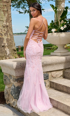 A woman wears a floor-length, pale pink V-neck lace Long Prom Dress: Faviana 11601 with a lace-up open back.