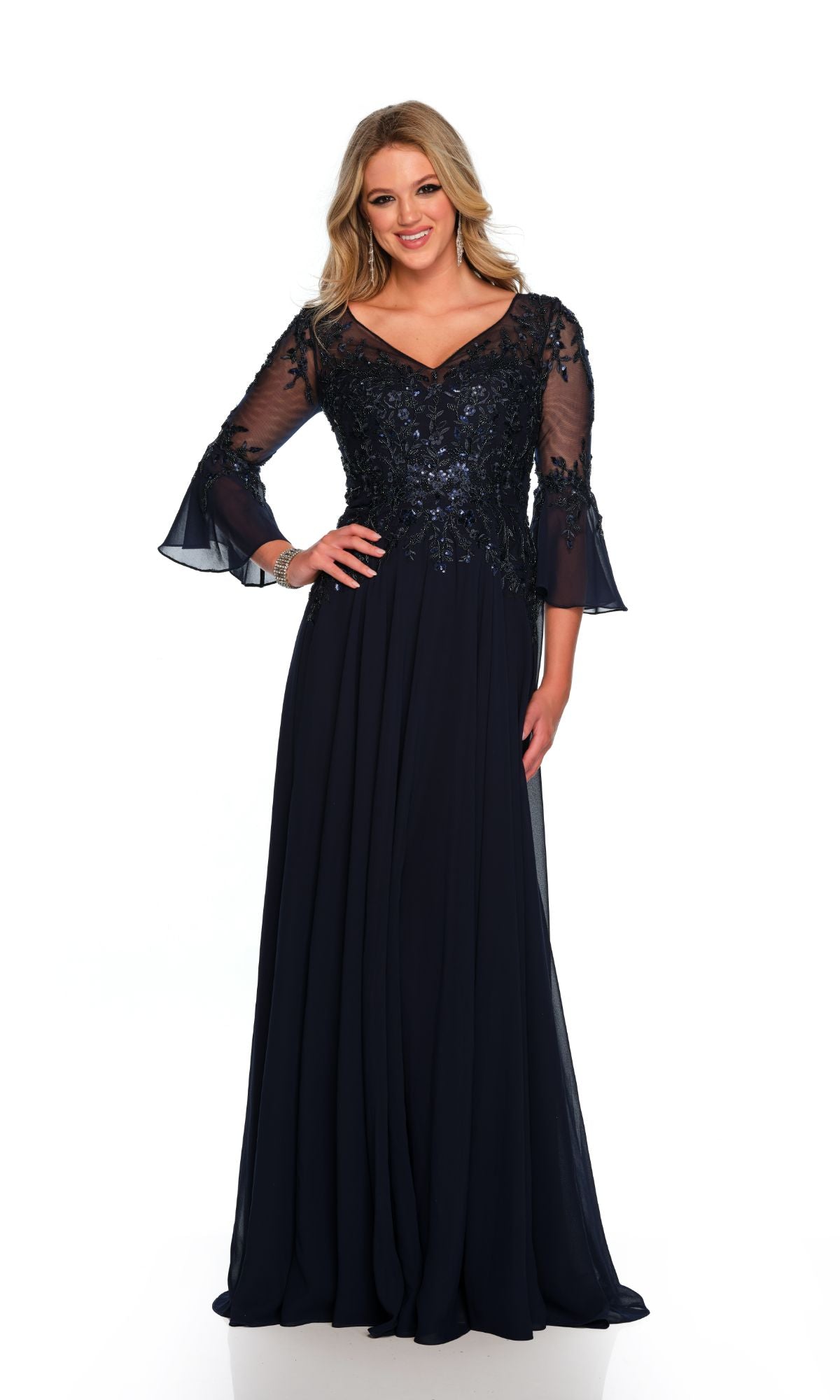 A woman faces forward in the Long Formal Dress 11602 by Dave and Johnny—a navy gown with sheer embroidered sleeves, a fitted embellished bodice, and a graceful v-neckline for an elegant, sophisticated look.