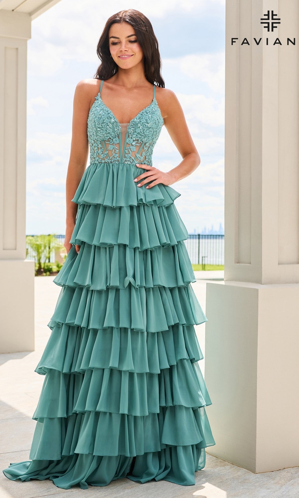 Faviana 11603 is a floor-length teal A-line prom dress featuring a beaded floral corset bodice, a plunging neckline, and a skirt of chiffon ruffles.