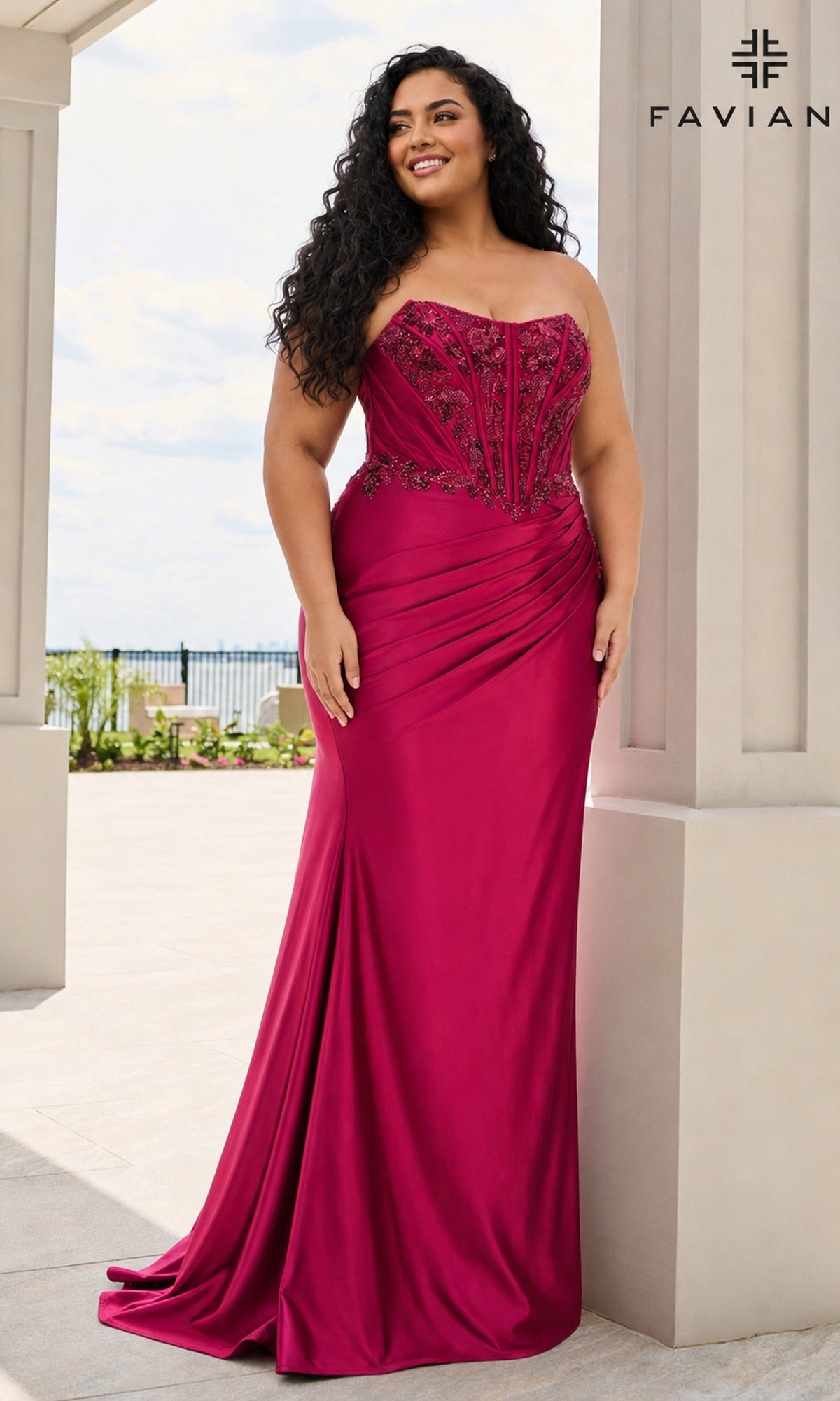 A plus-size person wears a Long Plus-Size Prom Dress: Faviana 11606E, a strapless, floor-length cherry red beaded corset dress with intricate embroidery and a draped skirt.