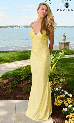 A woman stands outdoors wearing a floor-length, pale yellow V-neck Long Prom Dress: Faviana 11611 embellished with small pearls.
