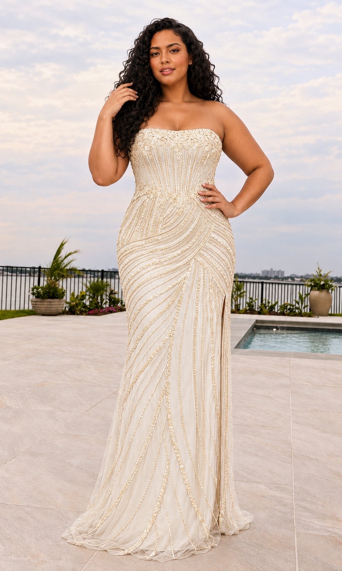A plus-size woman wears a Faviana 11615E strapless, ivory floor-length gown featuring gold beadwork and a side slit.