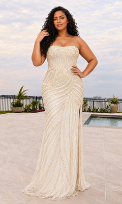 A plus-size woman wears a Faviana 11615E strapless, ivory floor-length gown featuring gold beadwork and a side slit.