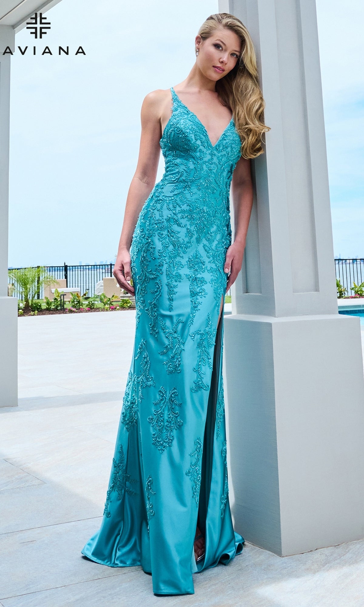 Faviana 11623 dark Pacific blue floor-length satin prom dress with a V-neckline, intricate beaded lace appliques, and a high side slit.