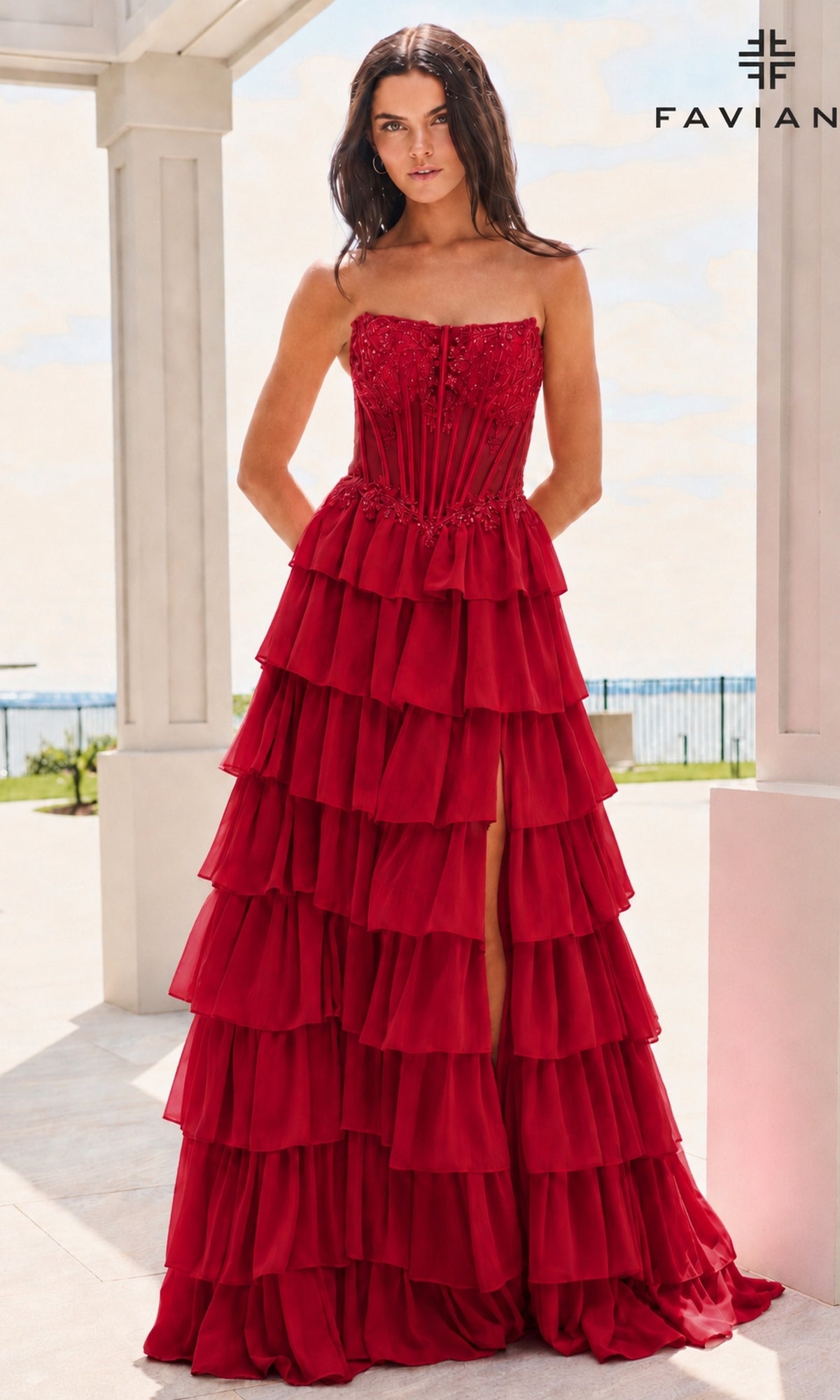 Faviana 11629 red strapless floor-length corset bodice gown featuring beaded embroidery and a tiered prom dress skirt with a side slit.
