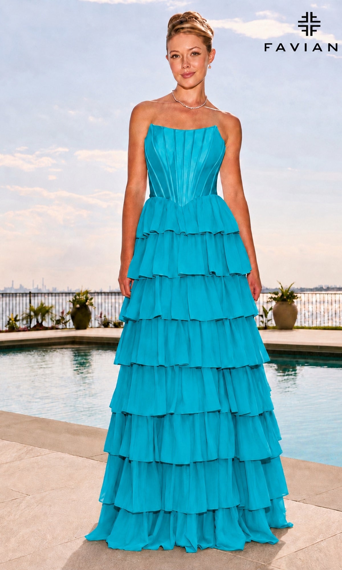 A woman stands by a swimming pool wearing an aqua Long Prom Dress: Faviana 11631, featuring a strapless floor-length design with a satin corset bodice and a tiered ruffled skirt.
