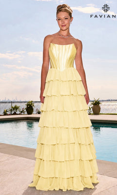 A woman wearing a light yellow Faviana 11631 long prom dress with a strapless, structured satin corset bodice and a multi-tiered ruffled skirt stands by a swimming pool.