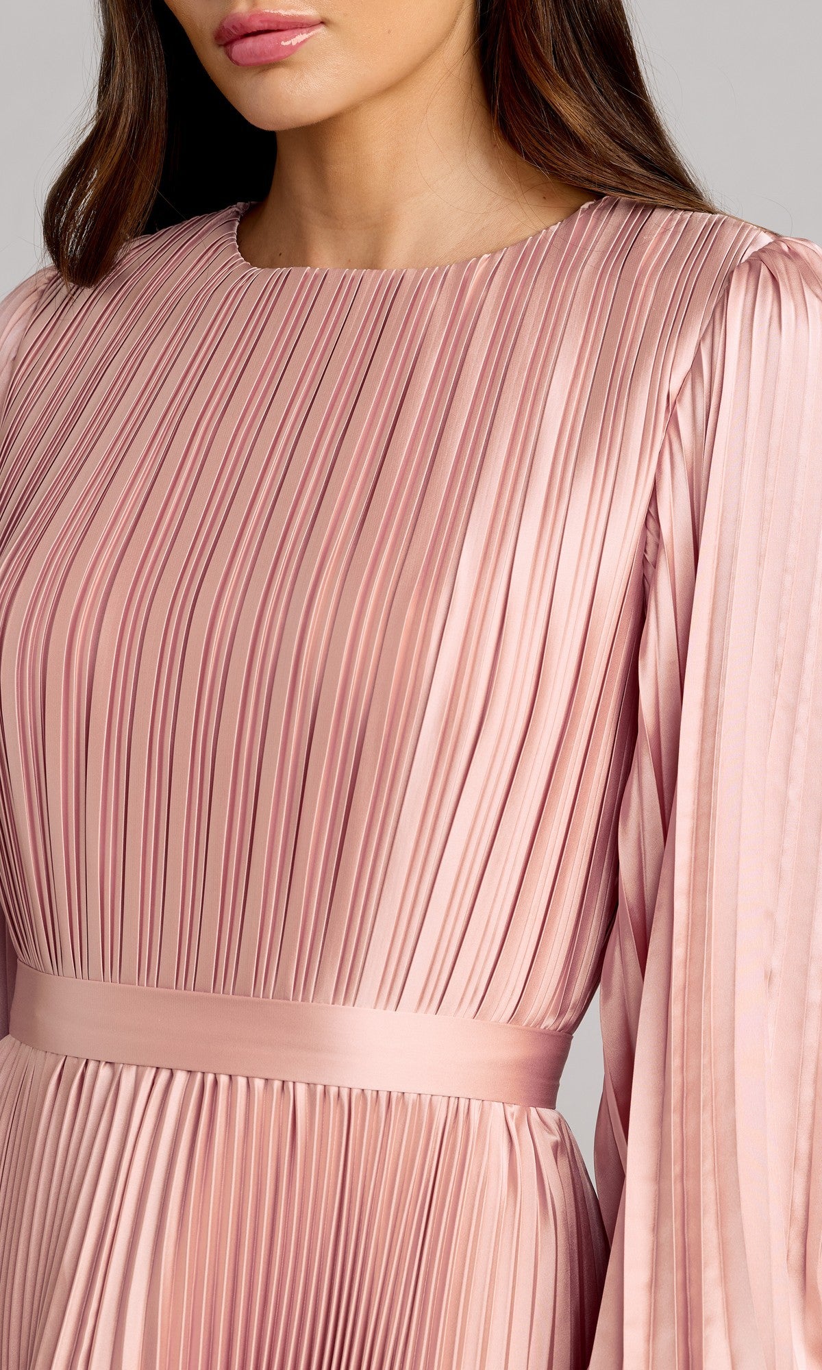 Woman wearing the Mac Duggal 11638 Fuchsia Midi Wedding Guest Dress, featuring pleats, long sleeves, a round neckline, and a matching waistband.