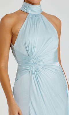 A woman wears the Mac Duggal 11642 High-Neck Long Prom Dress, a light blue satin halter gown featuring a high neckline and ruched waist detailing.