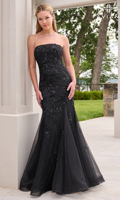 A woman in a Faviana 11643 long prom dress, a strapless black mermaid gown featuring intricate beadwork detailing.