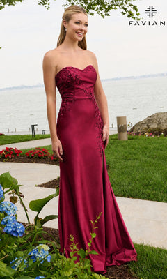 A woman wearing a cherry-red Faviana 11647 strapless floor-length gown with floral beaded appliques on the bodice.