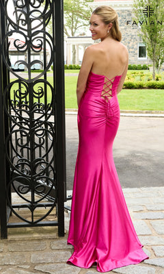 Back view of a woman in a Faviana 11649 hot pink strapless sweetheart prom dress with a floor-length satin skirt and a lace-up corset back.