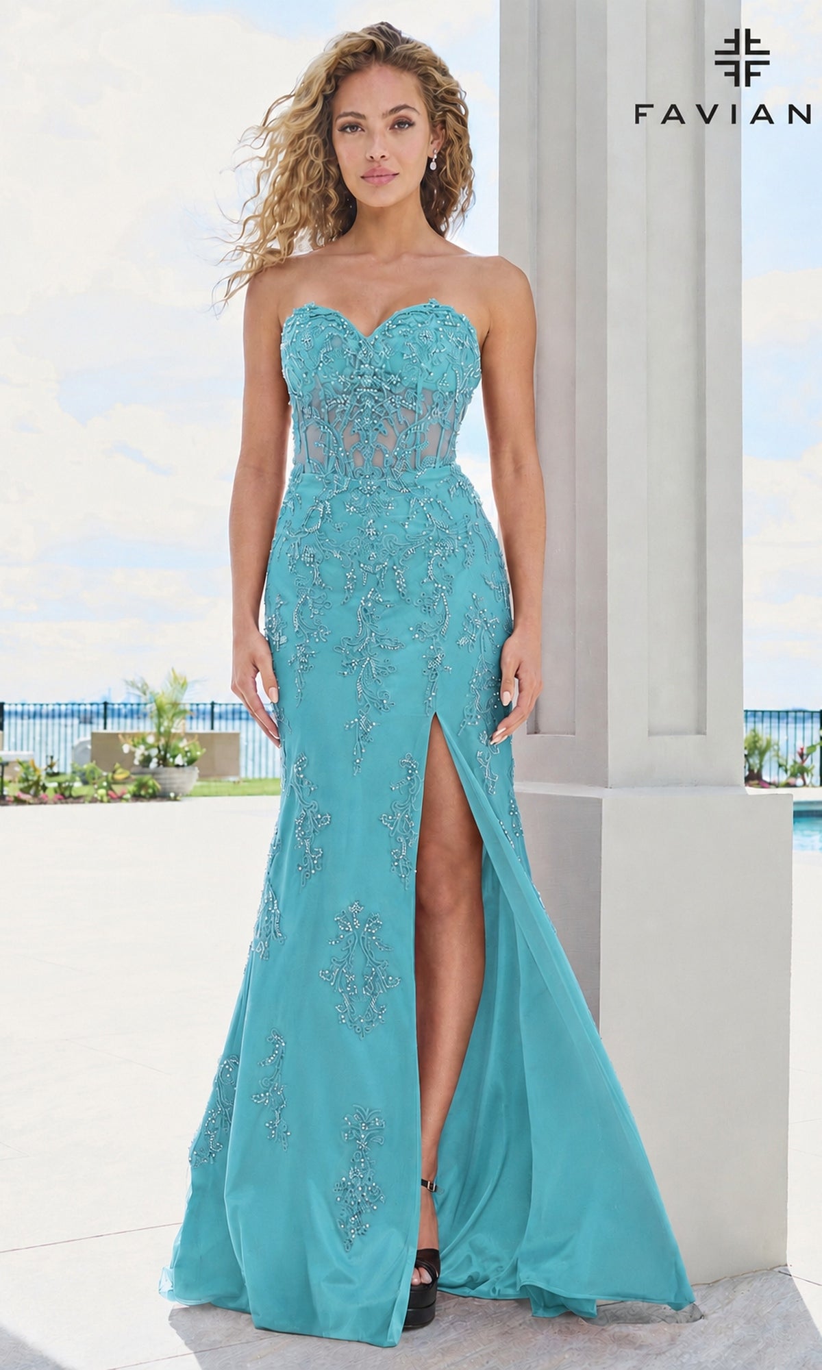 Faviana 11654 long prom dress in dark pacific blue, featuring a strapless sweetheart neckline, sheer corset bodice, intricate beaded lace appliques, and a floor-length skirt with a high thigh slit.