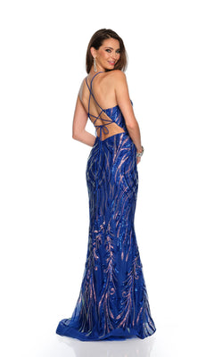 A woman wearing the Dave & Johnny Long Prom Dress 11671—a royal blue sequin gown with silver patterns and a lace-up back—stands looking over her shoulder against a white background, making a stunning choice for any formal event.