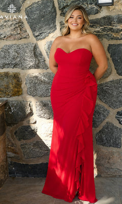 A woman wearing a Long Plus-Size Prom Dress: Faviana 11673E, a floor-length, strapless red dress with a sweetheart neckline and a ruffled side slit.