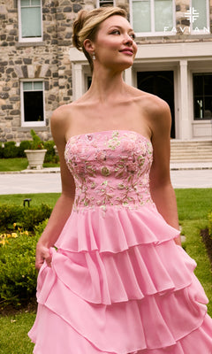 A woman wears the Faviana 11675 long prom dress, a strapless, light pink gown with an embroidered, floral-beaded bodice and a multi-tiered ruffled skirt.