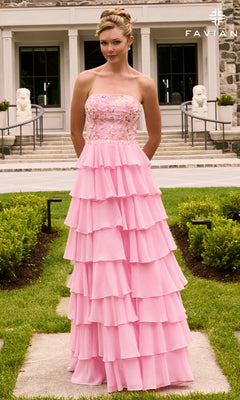 A woman wears a pink, floor-length Long Prom Dress: Faviana 11675 with a tiered ruffled skirt and an embellished, strapless bodice.