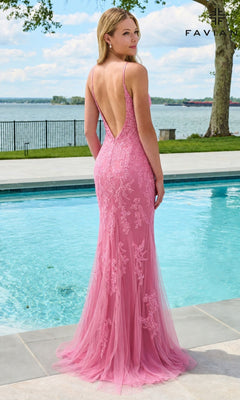 A woman stands by a swimming pool wearing a floor-length, backless pink Faviana 11678 gown featuring delicate beaded lace appliques.