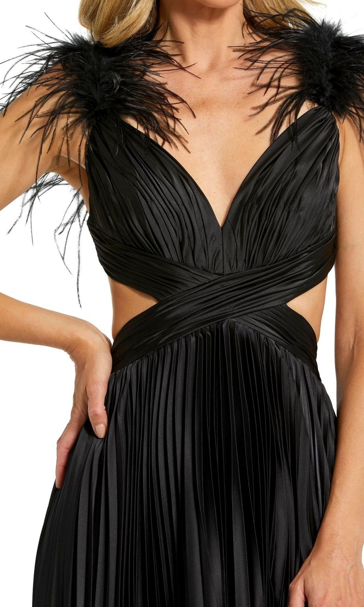 A woman wears the Mac Duggal Pleated Cut-Out Black Formal Dress 116871, featuring a sleeveless design, deep V-neck, pleated fabric, feather shoulder straps, and cut-out sides.
