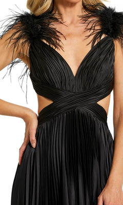 A woman wears the Mac Duggal Pleated Cut-Out Black Formal Dress 116871, featuring a sleeveless design, deep V-neck, pleated fabric, feather shoulder straps, and cut-out sides.