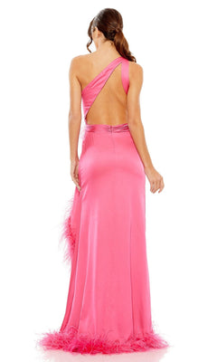 A woman faces away from the camera in the Feather Long Neon Formal Dress: Mac Duggal 11689—a bright pink, floor-length one-shoulder gown featuring an open back and feather trim at the hem.