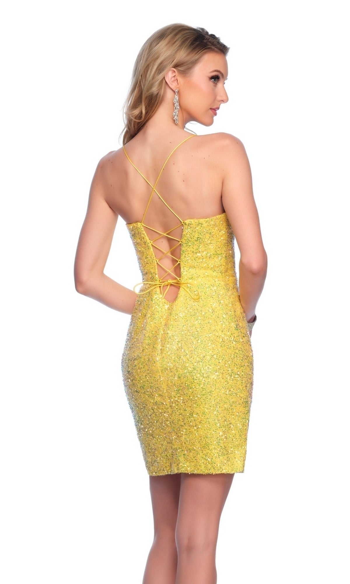 A woman stands with her back to the camera in the Dave and Johnny Short Yellow Hoco Dress 11758, a glittery, backless sequin dress featuring crisscross lacing.