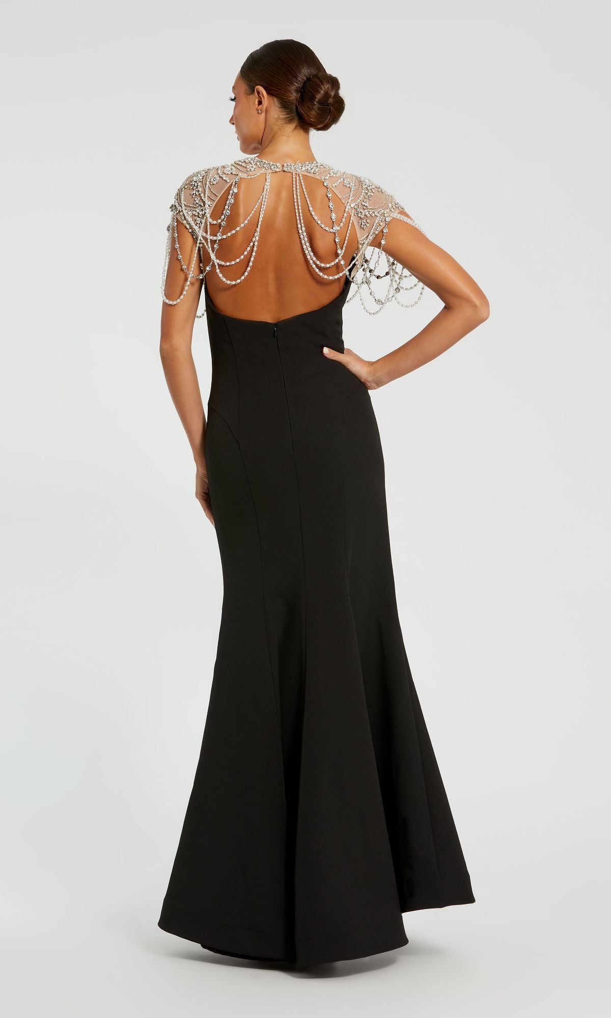 Woman wearing the Mac Duggal 11775 Pearl-Neckline Long Formal Dress—black with pearl-like beading on the shoulders and upper back—posing against a plain background.