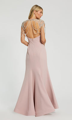 A woman models the Mac Duggal 11775 Pearl-Neckline Long Formal Dress in blush pink, featuring decorative beaded chains over her shoulders, standing against a plain white background.