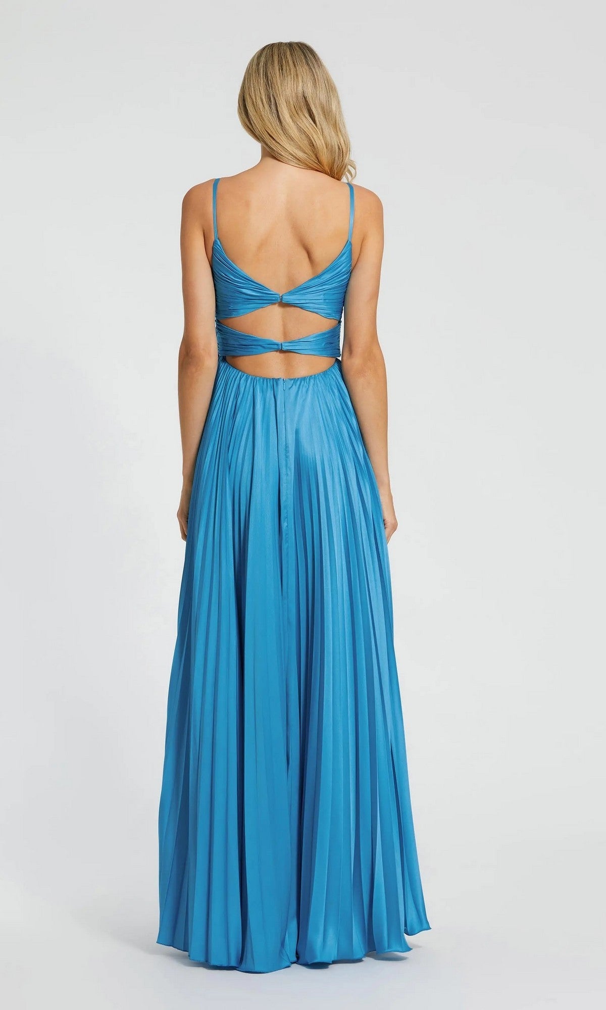 A woman stands against a plain white background wearing the Mac Duggal 11802 long formal dress—a pleated charmeuse gown with thin straps and an open, crisscross-detailed back.