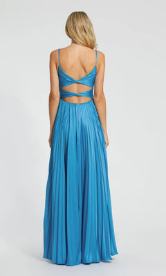 A woman stands against a plain white background wearing the Mac Duggal 11802 long formal dress—a pleated charmeuse gown with thin straps and an open, crisscross-detailed back.