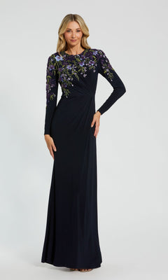 A woman wearing the Long Sleeve Blue Formal Dress by Mac Duggal 11806 stands against a plain background.