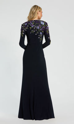 A woman stands facing away, wearing the Mac Duggal 11806—a long sleeve blue formal dress.