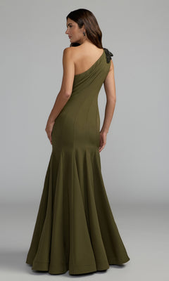 A woman stands facing away, wearing the Mac Duggal 11810 Beaded-One-Shoulder Prom Gown in olive green, featuring a fitted bodice and a flared skirt.