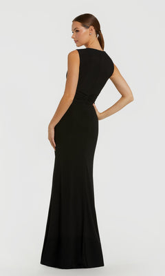 A woman faces away, wearing the Mac Duggal 11815 long formal dress—sleeveless, floor-length, fitted at the waist with delicate rhinestone flower accents—against a plain light backdrop.