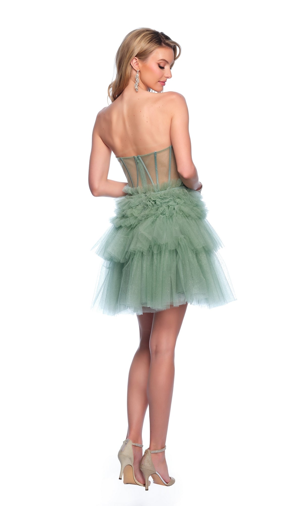 A woman poses with her back to the camera in the Dave & Johnny Short Green Ruffle Hoco Dress 11826, featuring a strapless corset-style bodice and tiered tulle skirt, set against a white background.
