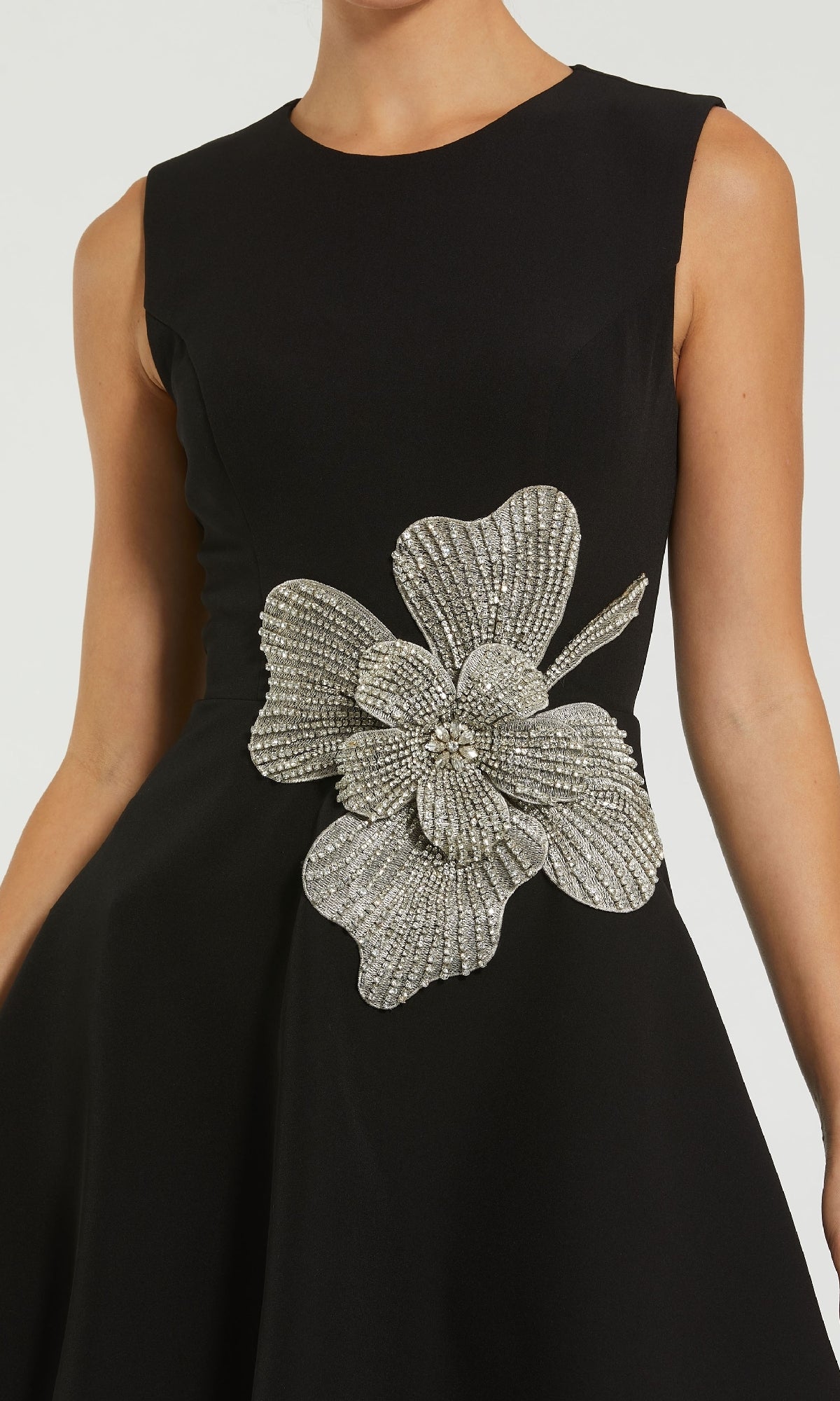 The Short Black Cocktail Dress: Mac Duggal 11829 is a sleeveless black party dress with a striking silver beaded floral embellishment at the waist—perfect for an elegant evening look.