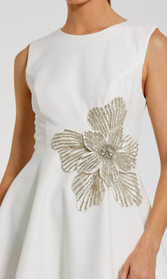 A woman wearing a sleeveless black Mac Duggal 11829 cocktail dress.