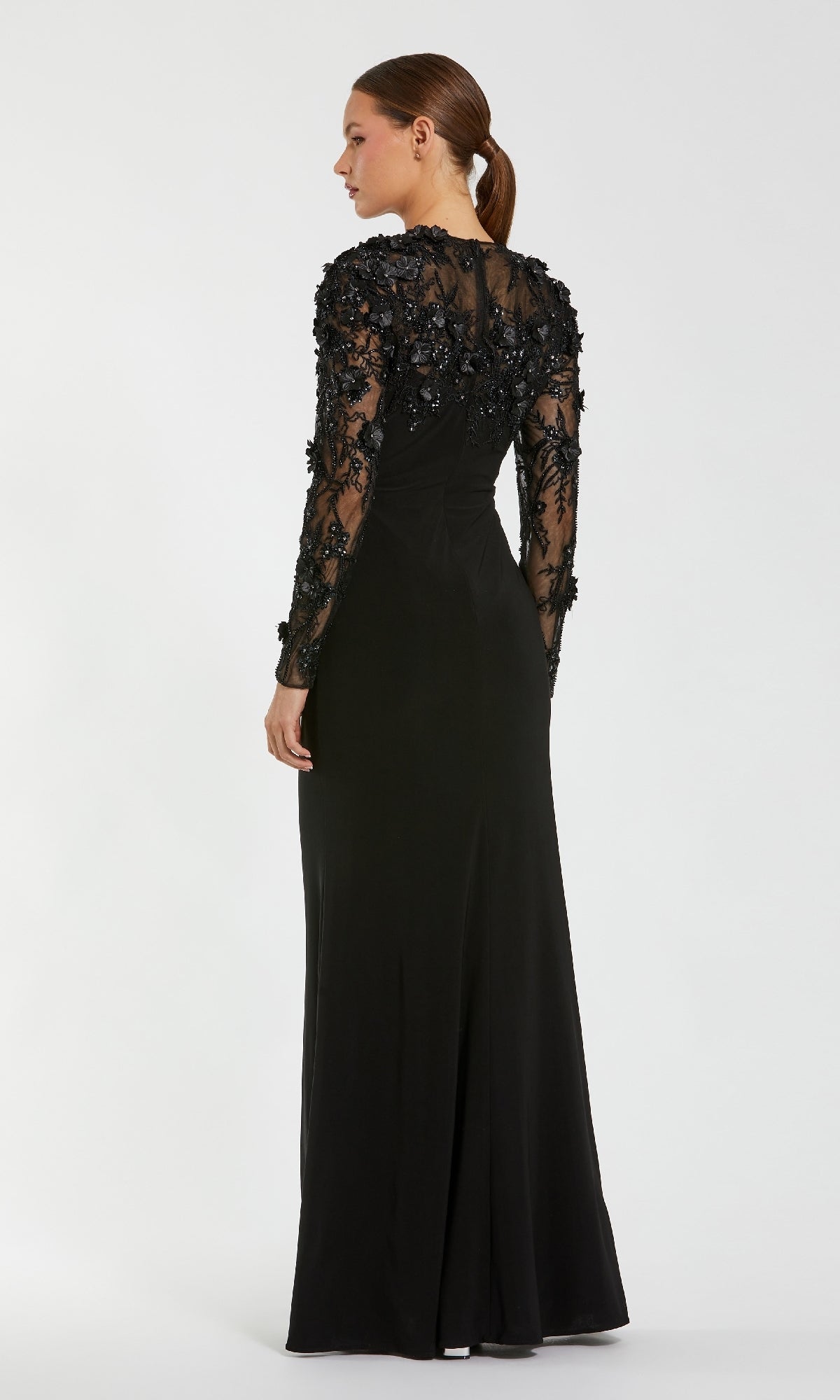 Black evening gown with long sheer sleeves on a white background