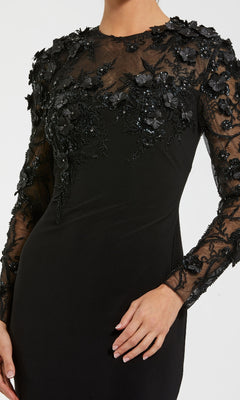 Black dress with embellished long sheer sleeves on a white background