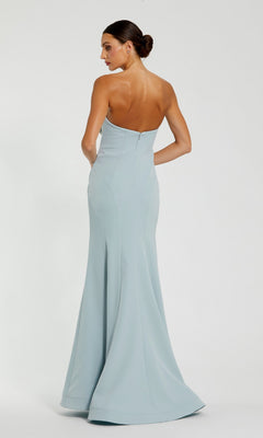 A woman stands with her back to the camera against a plain background, wearing the Mac Duggal 11855 Strapless Floral Formal Gown in light blue.