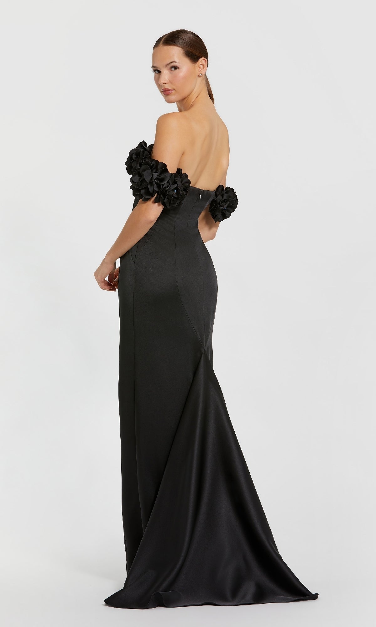 Black evening gown with floral details on a white background