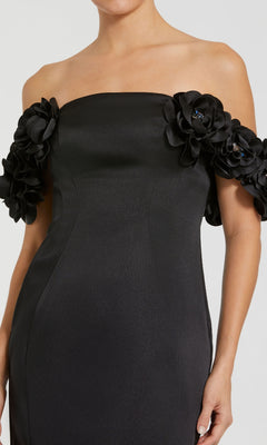 Black off-shoulder dress with floral details on a white background