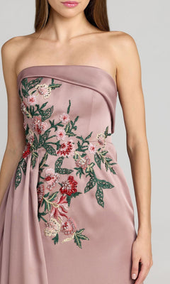 A woman wearing the Mac Duggal 11894 long formal dress—a mauve satin strapless A-line gown adorned with exquisite pink, red, and green floral embroidery on the bodice and side.