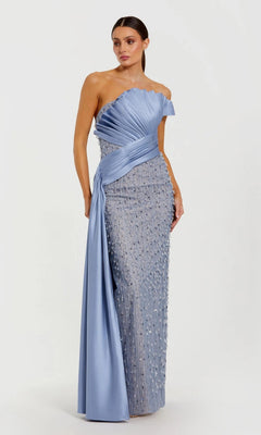 A woman poses against a white background in the Mac Duggal 11909 Long Formal Dress—a one-shoulder, floor-length gown in Fusion Blue, featuring pleated satin details and beaded embellishments.