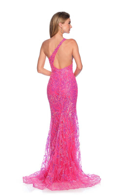 A woman models the Long Prom Dress: Dave and Johnny 11925, a bright fuchsia pink, one-shoulder sequin gown with an open back, set against a white background.