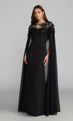 A woman wearing the Mac Duggal 11954 long black formal dress, featuring crepe fabric, chiffon cape sleeves, and intricate sequin floral embroidery on the bodice, stands against a plain background.