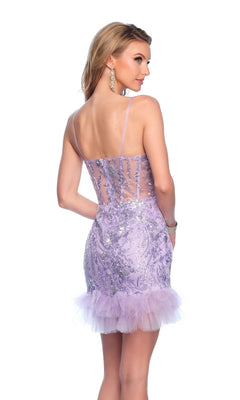 A woman stands with her back to the camera in the Lilac Purple Homecoming Dress 11958, featuring sequins, sheer back panels, and tulle trim.