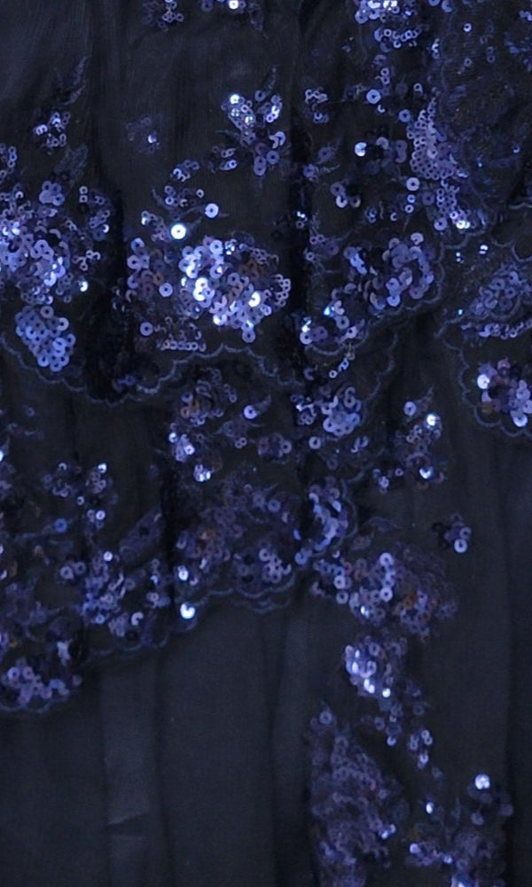 Close-up of dark blue mesh fabric with shiny blue sequins in a scattered floral pattern—featured on the Sequin Blue Homecoming Dress 11961, perfect for making a statement.