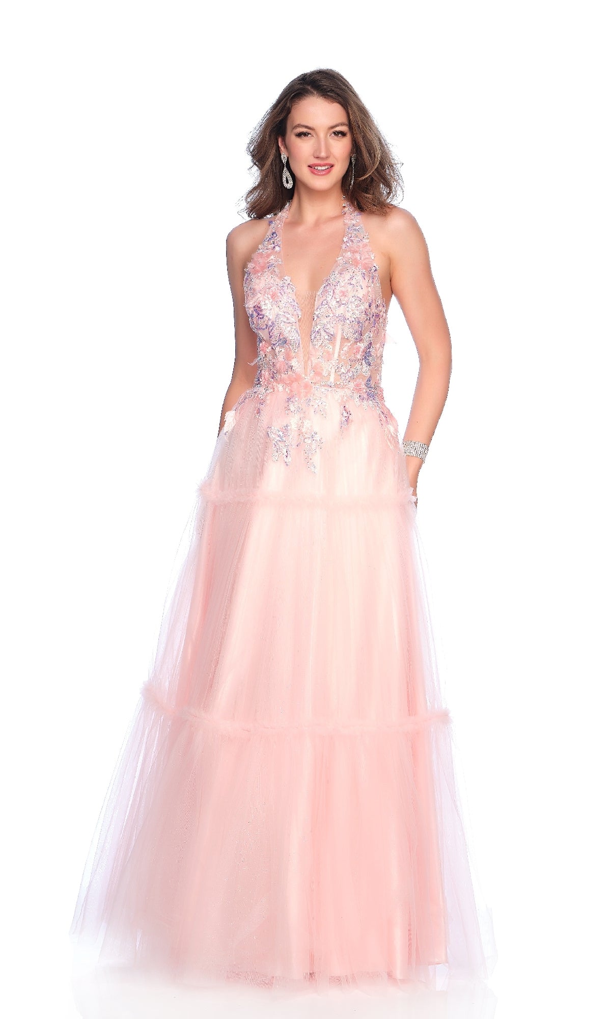 Woman wearing the Dave & Johnny 11966 Light Pink Halter Prom Dress, featuring floral embroidery, an A-line skirt, and a deep V neckline, standing against a white background.