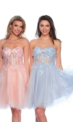 Two women stand side by side in strapless, knee-length dresses: one wears the Sheer Glitter Homecoming Dress 11973 in pink with a sheer corset, while the other dazzles in a light blue, floral embroidered homecoming dress.